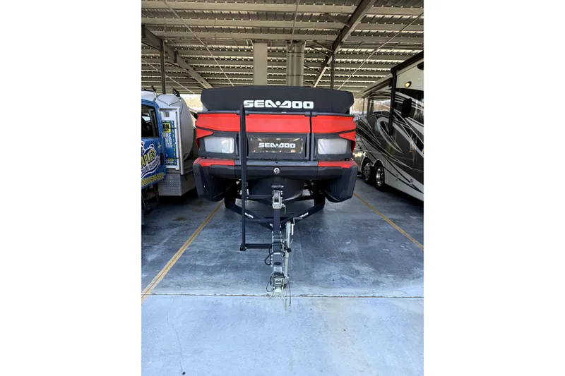 Slide: The Image of 2022 Sea-Doo Switch Cruise 18 parked in covered storage area. - 2