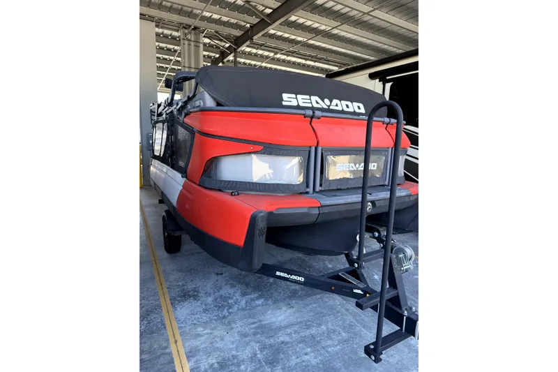 Slide: The Image of 2022 Sea-Doo Switch Cruise 18 in storage, featuring a vibrant red exterior. - 3