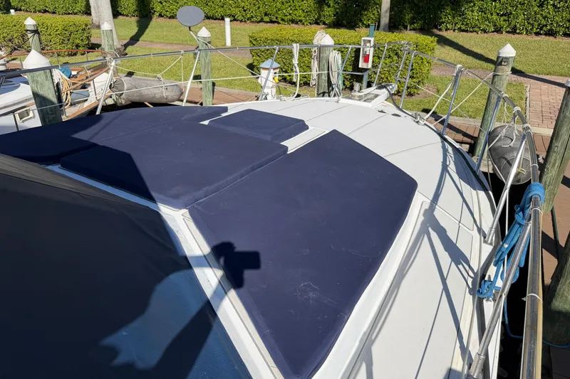 Slide: The Image of 1987 Hi-Star 55 Yacht Fisherman docked, featuring blue deck cushions and railing. - 1