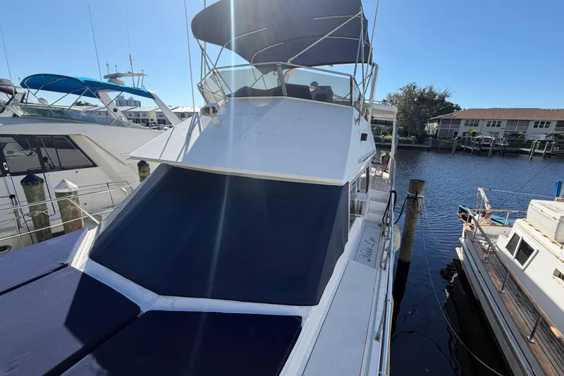 Slide: The Image of 1987 Hi-Star 55 Yacht Fisherman docked, featuring sleek design and spacious deck. - 3