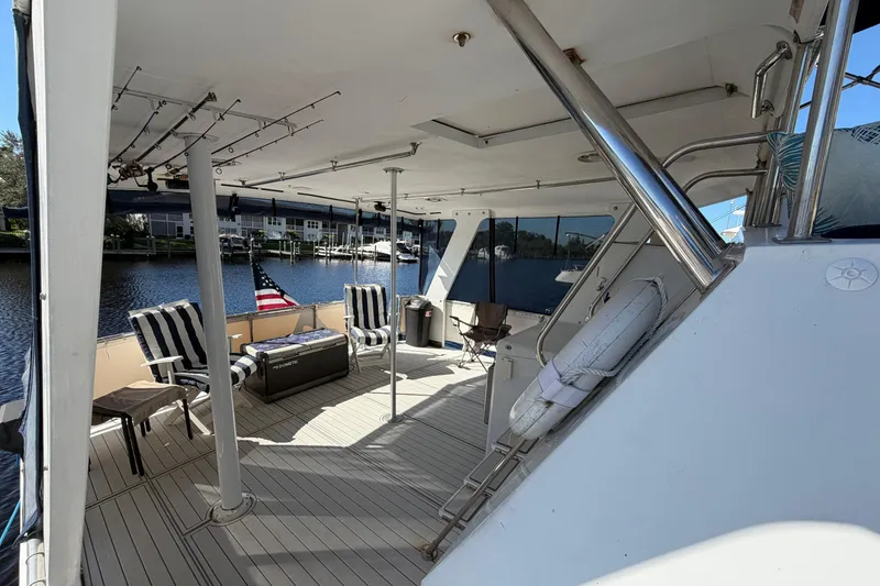 Slide: The Image of 1987 Hi-Star 55 Yacht Fisherman deck with seating, fishing rods, and American flag. - 4