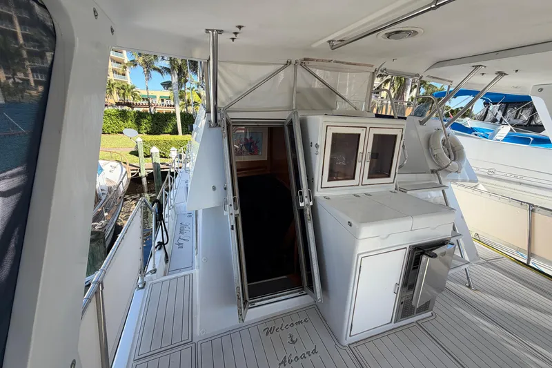 Slide: The Image of 1987 Hi-Star 55 Yacht Fisherman deck with open cabin door and welcome mat. - 8