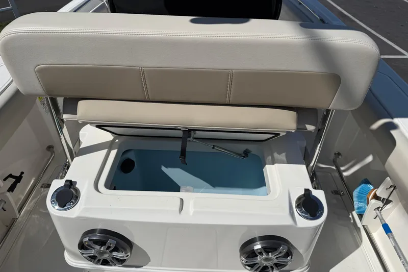 Slide: The Image of 2022 Boston Whaler 230 Outrage boat interior with seating and storage compartment. - 2