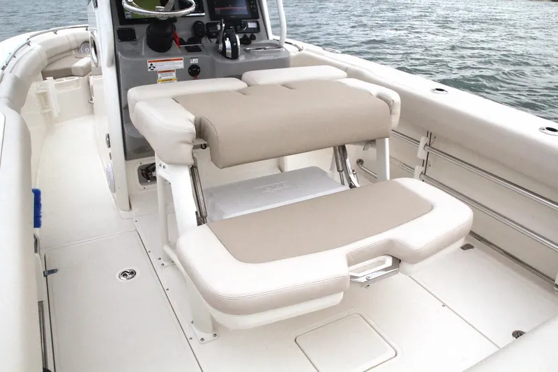 Slide: The Image of Boston Whaler 230 Outrage 2022 interior view with seating bench. - 23