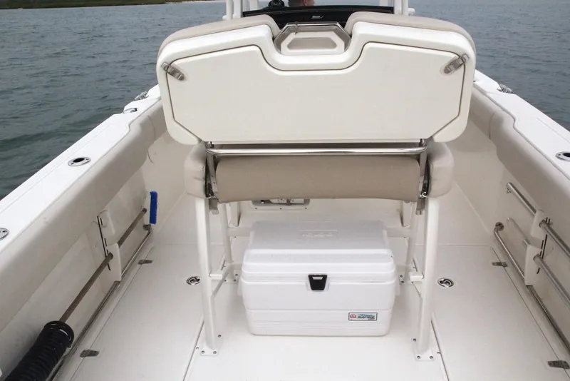 Slide: The Image of Interior of 2022 Boston Whaler 230 Outrage with bench seat and cooler. - 25