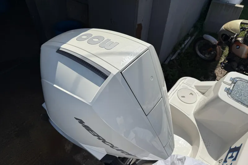 Slide: The Image of Outboard motor on a 2022 Boston Whaler 230 Outrage boat, parked outdoors. - 4