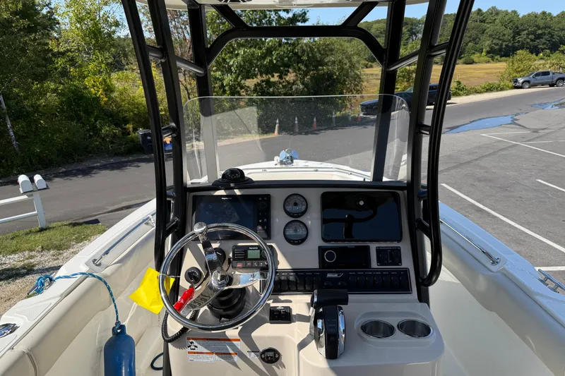 Slide: The Image of 2022 Boston Whaler 230 Outrage boat dashboard with steering wheel and controls. - 5