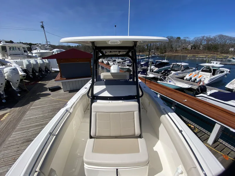 Slide: The Image of Boston Whaler 230 Outrage 2022 at a dock with other boats. - 9