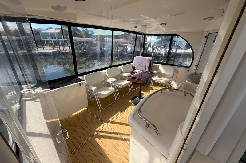 Slide: The Image of Interior of 2002 Sea Ray 480 Motor Yacht with seating and table, dockside view. - 12