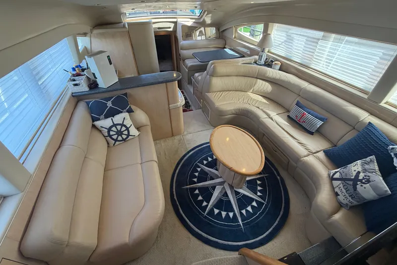 Slide: The Image of Luxurious interior of 2002 Sea Ray 480 Motor Yacht with plush seating and nautical decor. - 16