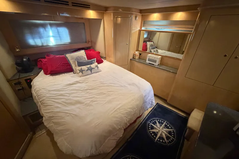 Slide: The Image of Luxurious 2002 Sea Ray 480 Motor Yacht bedroom with cozy bedding and elegant wood finishes. - 28