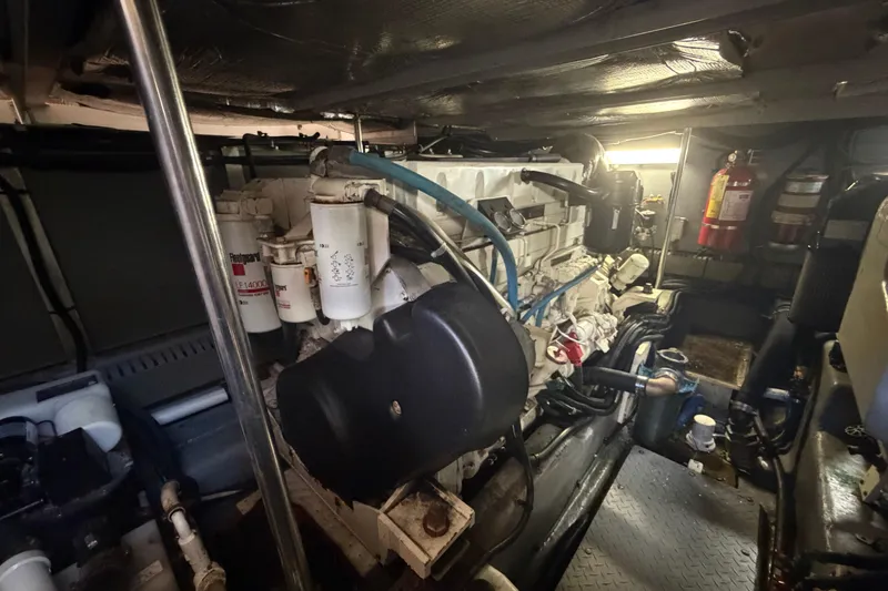 Slide: The Image of Engine room of a 2002 Sea Ray 480 Motor Yacht, featuring mechanical components and fire extinguisher. - 36