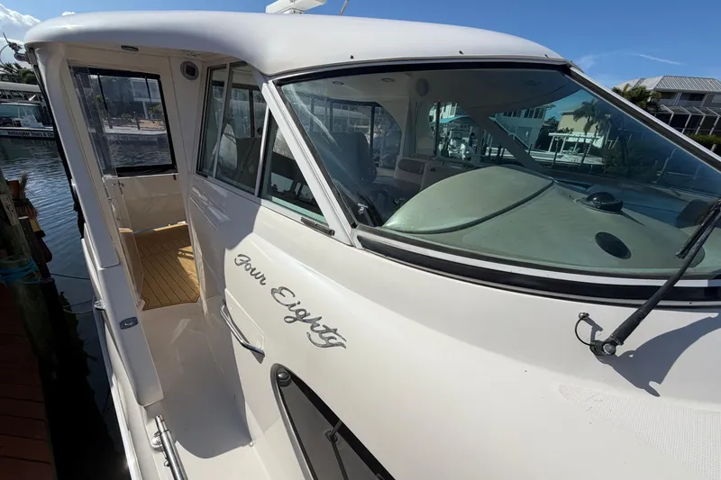 Slide: The Image of 2002 Sea Ray 480 Motor Yacht docked, showcasing sleek design and spacious interior. - 7