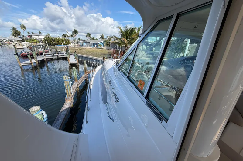 Slide: The Image of 2002 Sea Ray 480 Motor Yacht docked at marina, clear sky, palm trees in background. - 9