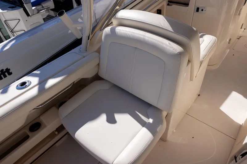 Slide: The Image of 2022 Grady-White Freedom 275 boat interior with white seating and sleek design. - 12
