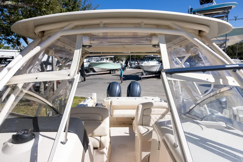 Slide: The Image of 2022 Grady-White Freedom 275 boat interior with clear canopy and seating. - 19