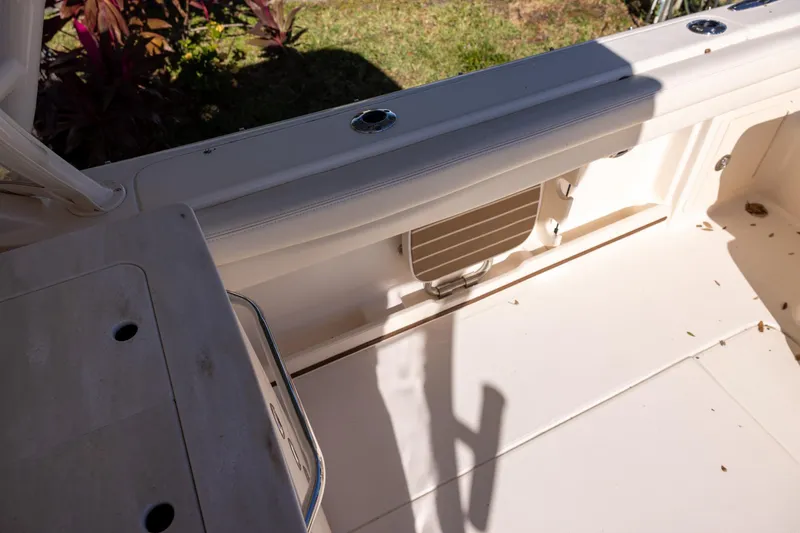 Slide: The Image of 2022 Grady-White Freedom 275 boat interior, featuring seating and storage area. - 7