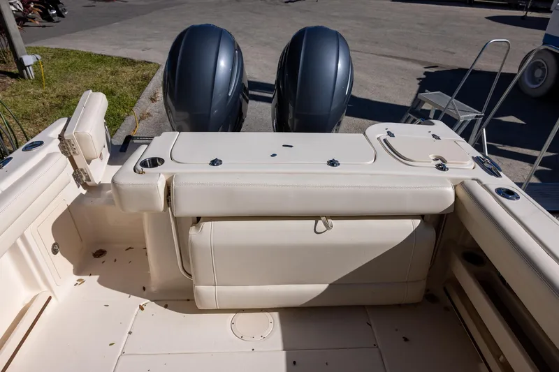 Slide: The Image of 2022 Grady-White Freedom 275 boat interior with dual engines and seating area. - 8
