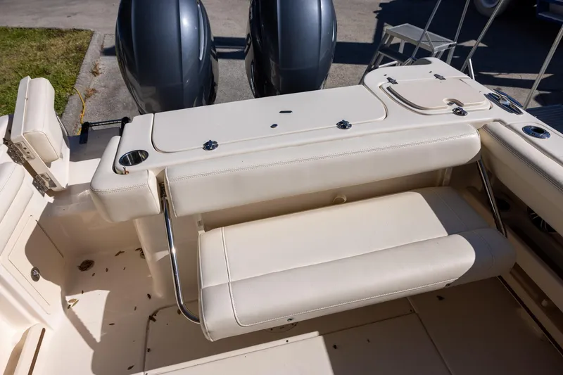 Slide: The Image of 2022 Grady-White Freedom 275 boat interior with seating and dual engines. - 9