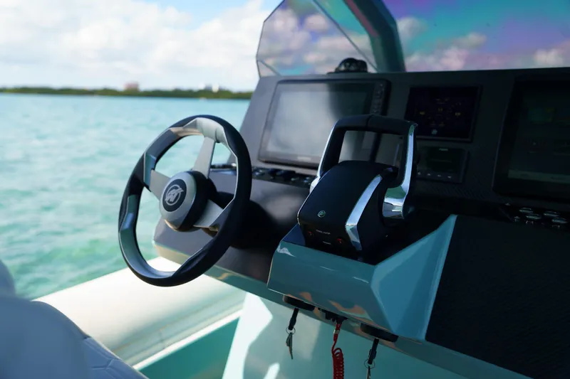 Slide: The Image of Steering wheel and controls of 2025 Novielli Veloche boat on open water. - 13