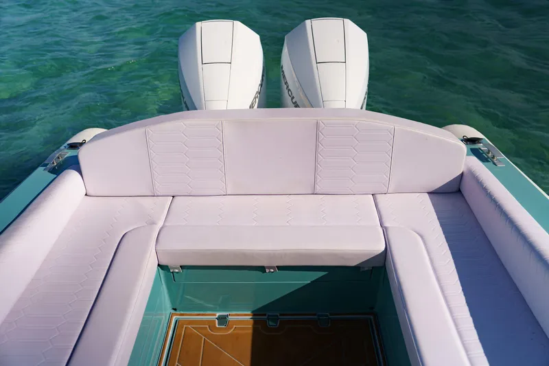 Slide: The Image of Luxury Novielli Veloche 2025 boat interior with white seating and dual engines on turquoise water. - 17