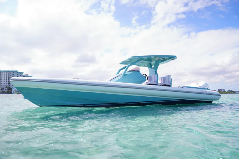 Slide: The Image of 2025 Novielli Veloche boat on clear turquoise water under a partly cloudy sky. - 21