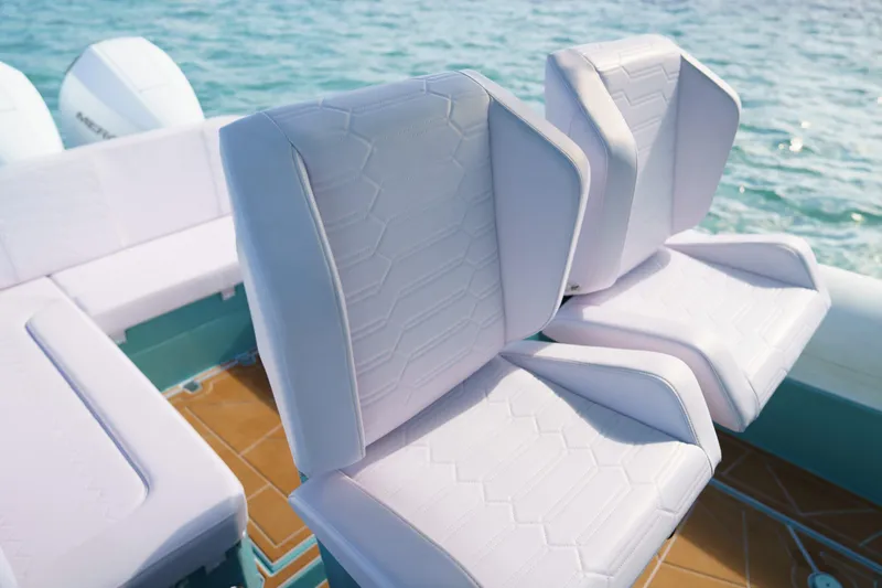 Slide: The Image of 2025 Novielli Veloche boat seats with white upholstery, set against a serene ocean backdrop. - 9