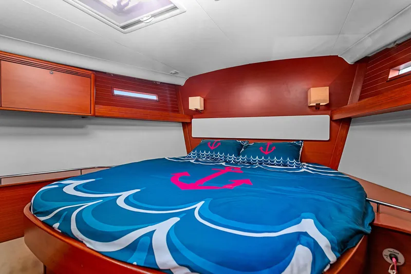 Slide: The Image of Luxurious cabin interior of 2011 Dufour 525 Grand Large yacht with nautical-themed bedding. - 28