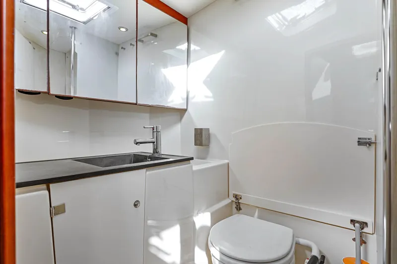 Slide: The Image of Modern bathroom in 2011 Dufour 525 Grand Large yacht, featuring sleek sink and toilet. - 30