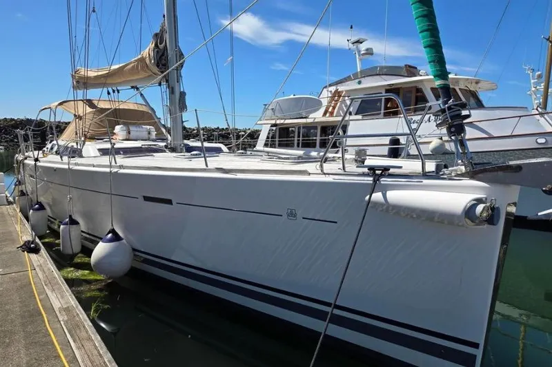 Slide: The Image of 2011 Dufour 525 Grand Large sailboat docked at marina under clear blue sky. - 43