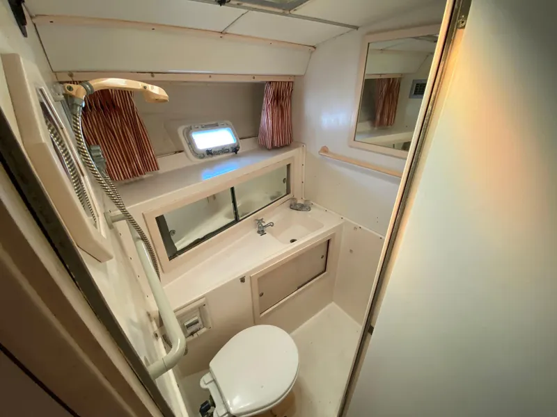 Slide: The Image of 1982 Bertram 46.6 War Wagon bathroom with shower, sink, and toilet. - 33
