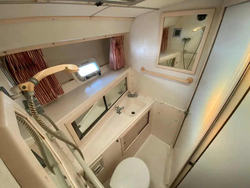 Slide: The Image of 1982 Bertram 46.6 War Wagon bathroom with shower, sink, and mirror. - 34