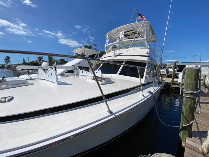 Slide: The Image of 1982 Bertram 46.6 War Wagon yacht docked under clear blue sky. - 4