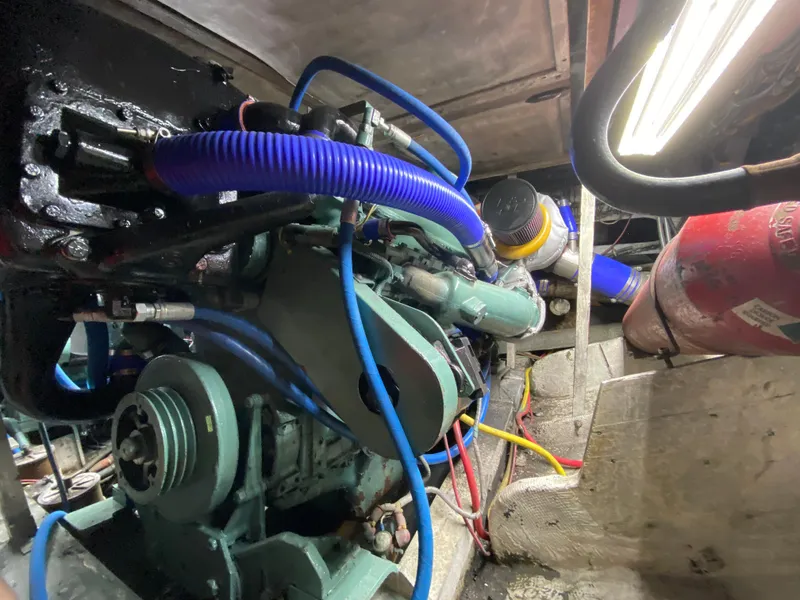 Slide: The Image of Engine room of 1982 Bertram 46.6 War Wagon with visible machinery and wiring. - 40