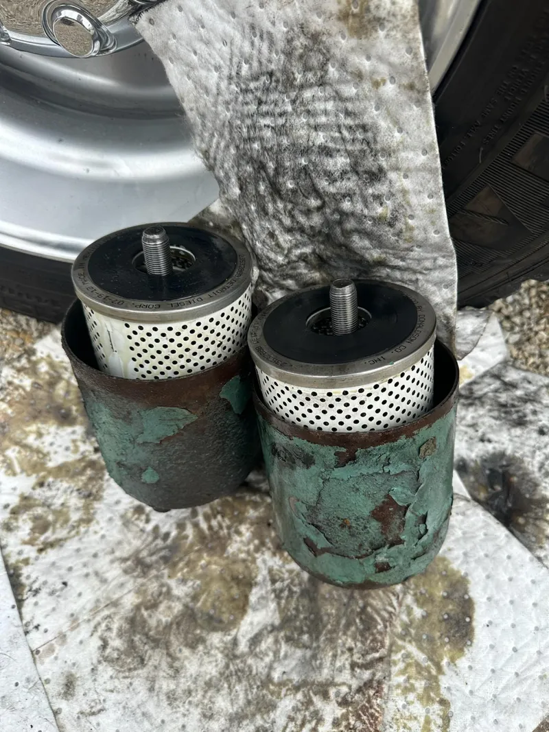 Slide: The Image of Rusty filters from a 1982 Bertram 46.6 War Wagon on a stained cloth. - 43