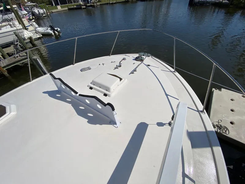 Slide: The Image of 1982 Bertram 46.6 War Wagon yacht deck, docked in a serene marina. - 6