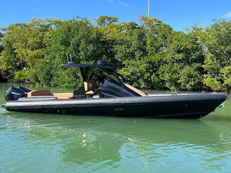 Slide: The Image of 2026 Novielli Veloche 349 boat on calm water, surrounded by lush greenery. - 12