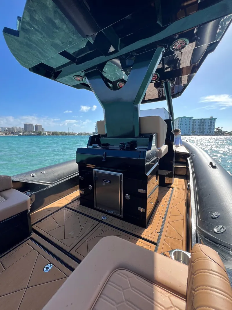 Slide: The Image of Luxury Novielli Veloche 349 boat interior, 2026 model, on clear blue water with city skyline. - 9