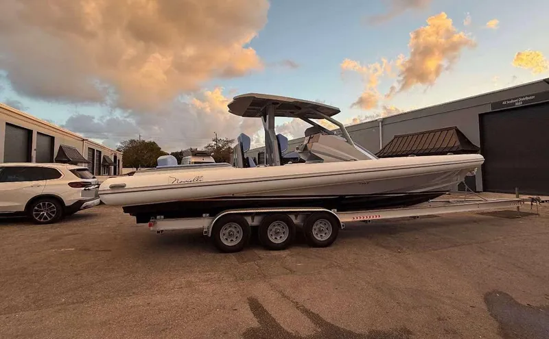 The Image of 2026 Novielli Veloche 349 boat on trailer, parked outdoors at sunset. - 1