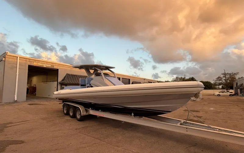 Slide: The Image of 2026 Novielli Veloche 349 boat on trailer at sunset near boatyard. - 2