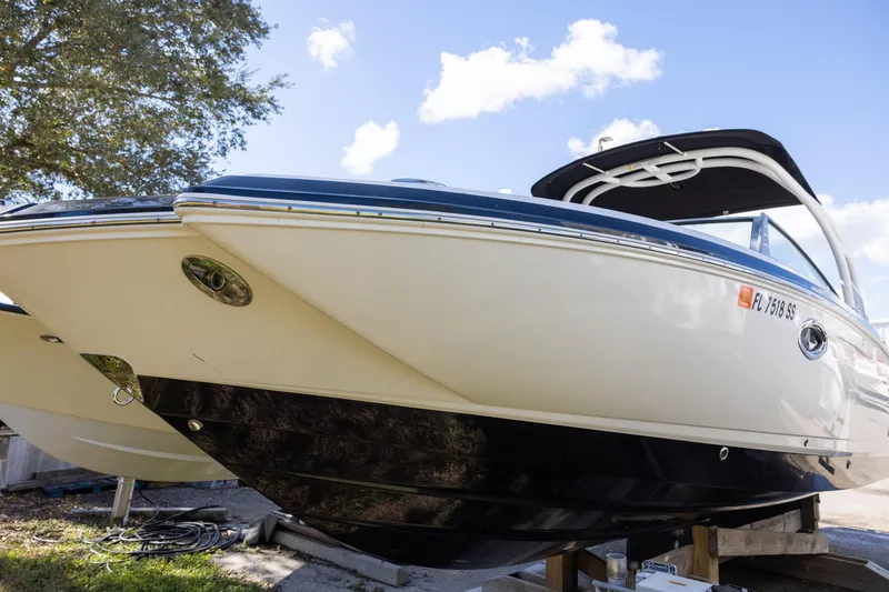 Slide: The Image of 2018 Chaparral 264 Sunesta boat on display under a clear blue sky. - 1