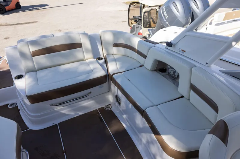 Slide: The Image of 2018 Chaparral 264 Sunesta boat interior with white and brown seating. - 5