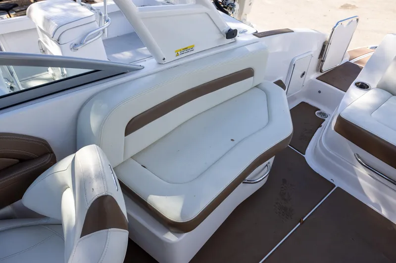 Slide: The Image of 2018 Chaparral 264 Sunesta boat interior with white and brown seating. - 6