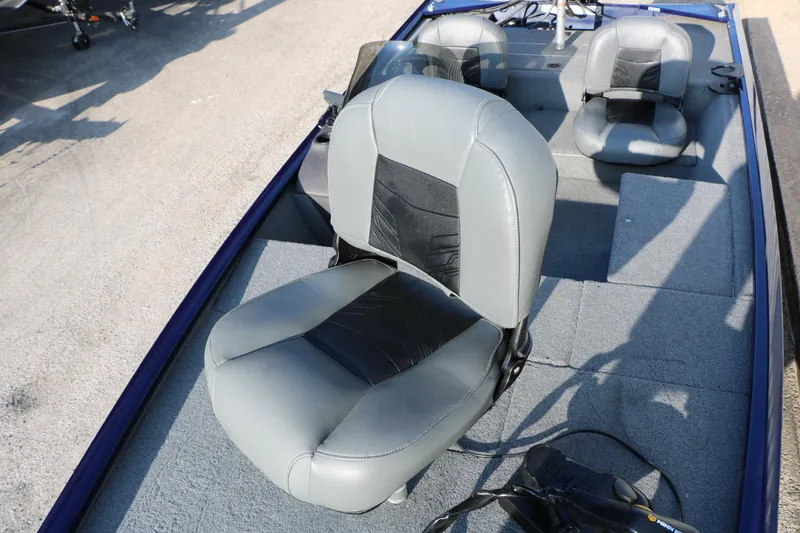 Slide: The Image of 2019 Tracker Pro 170 boat interior with gray seating and carpeted flooring. - 17