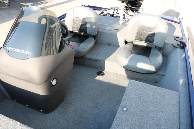 Slide: The Image of 2019 Tracker Pro 170 boat interior with two gray seats and steering console. - 18