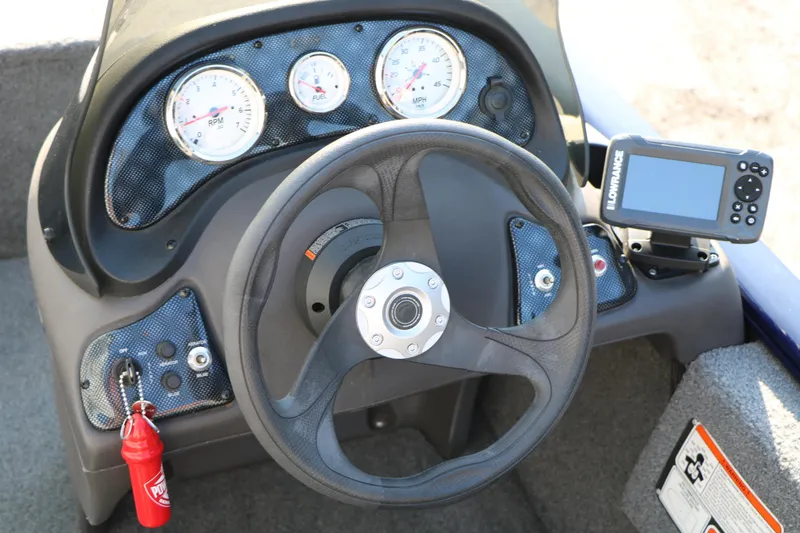 Slide: The Image of 2019 Tracker Pro 170 boat dashboard with steering wheel, gauges, and Lowrance fish finder. - 21