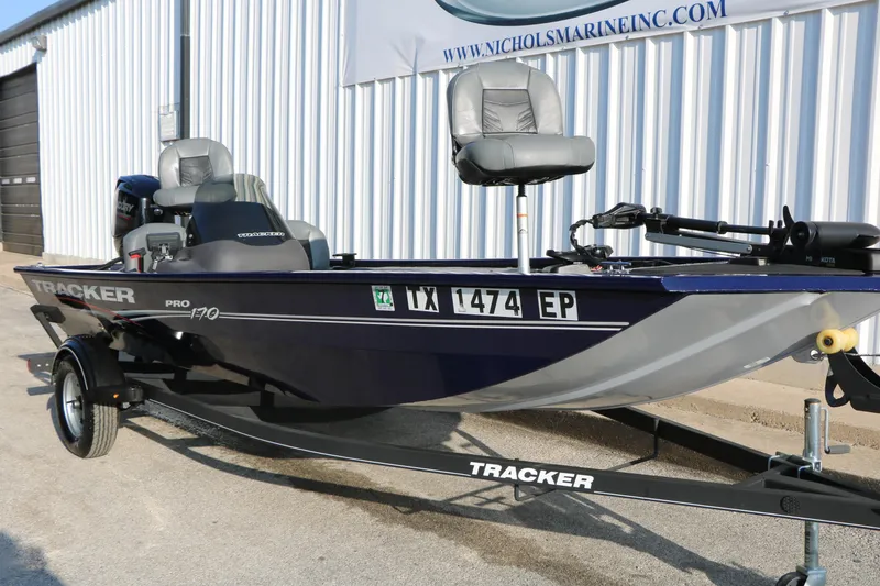 Slide: The Image of 2019 Tracker Pro 170 boat on trailer, parked outside a marine dealership. - 3