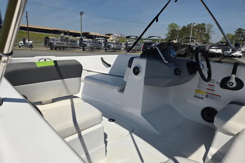 Slide: The Image of Interior of a 2022 Tahoe T16 boat, featuring seating and steering console. - 10