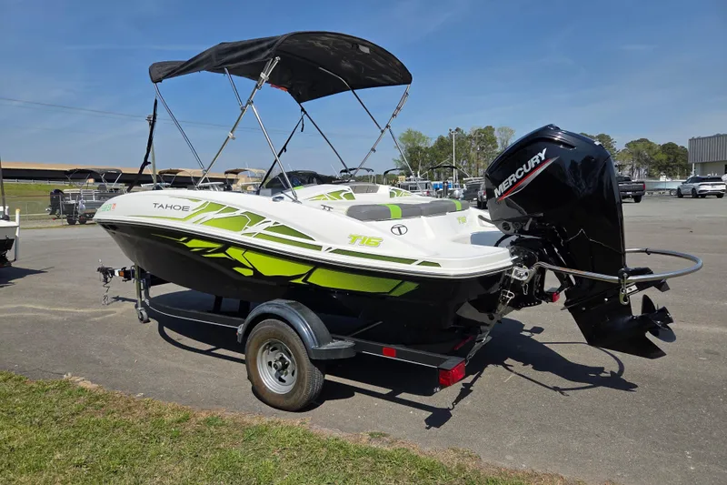 Slide: The Image of 2022 Tahoe T16 boat with Mercury engine on trailer, featuring vibrant green accents. - 5
