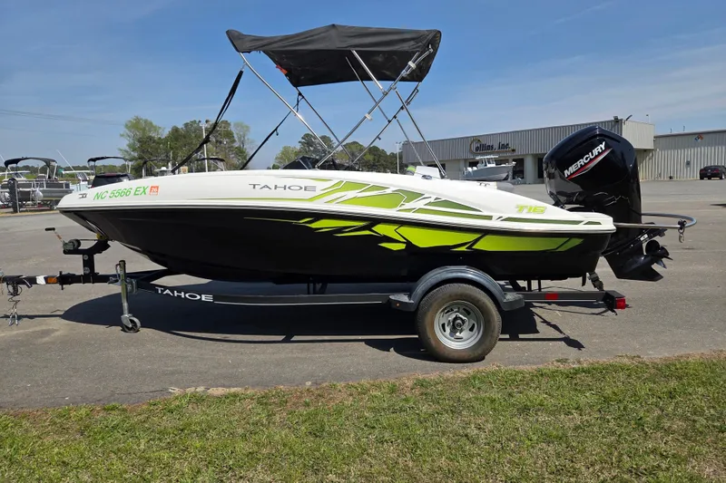 Slide: The Image of 2022 Tahoe T16 boat with trailer, featuring vibrant green accents and a Mercury outboard motor. - 6